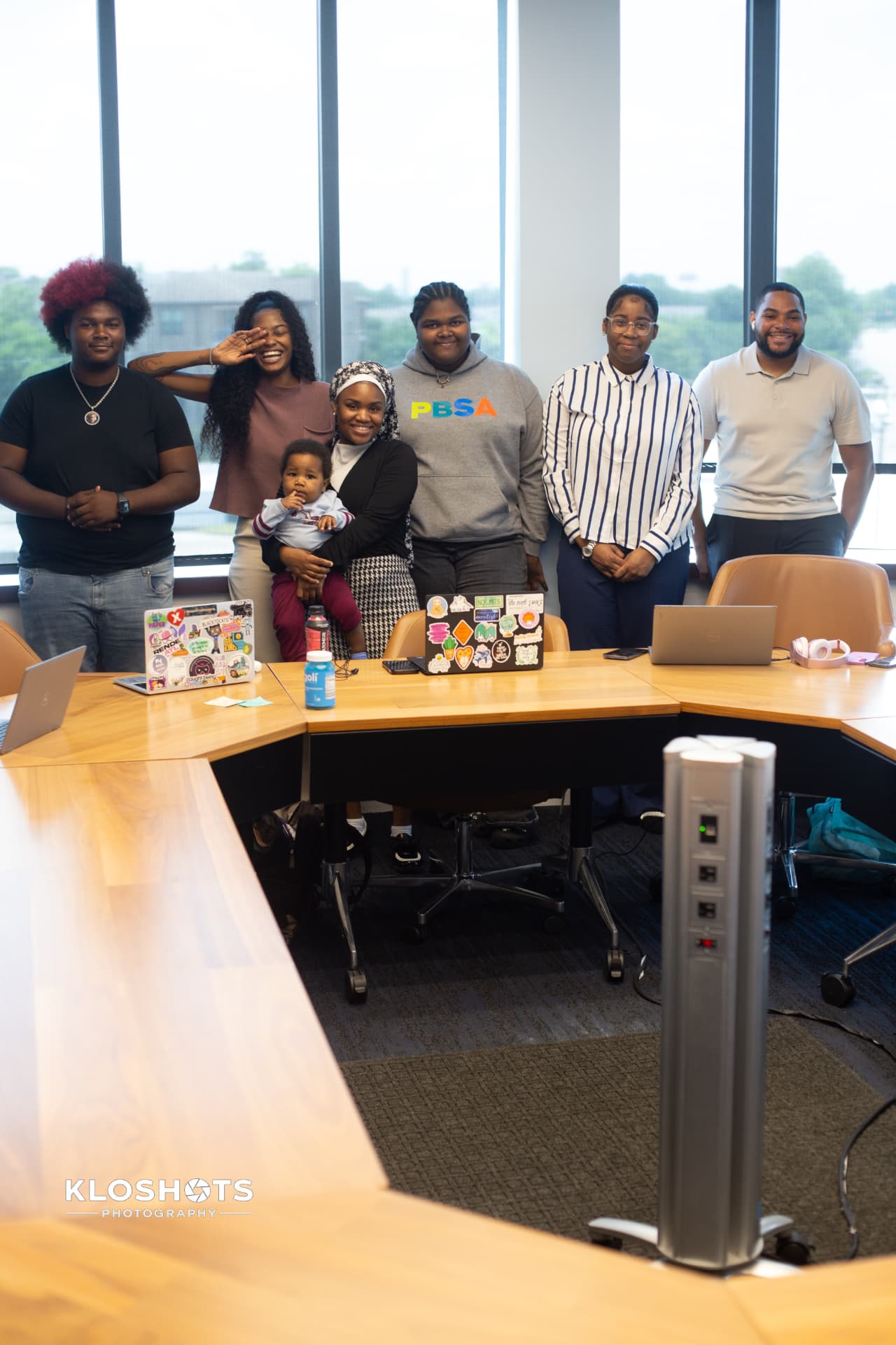 RealChill Education cohort standing together in a conference room after a working session