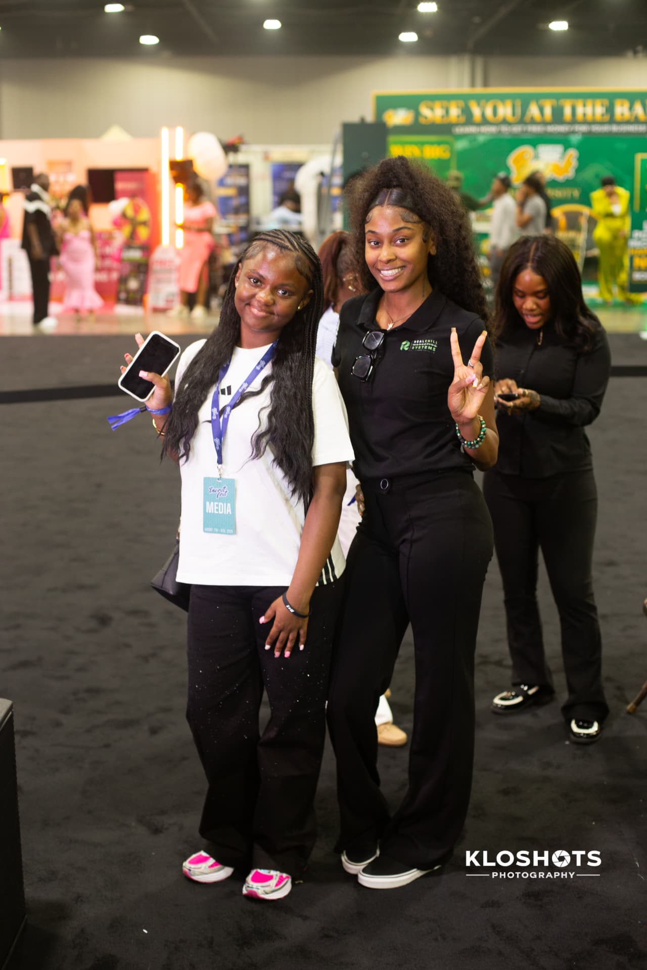 Two RealChill team members with media credentials at an expo