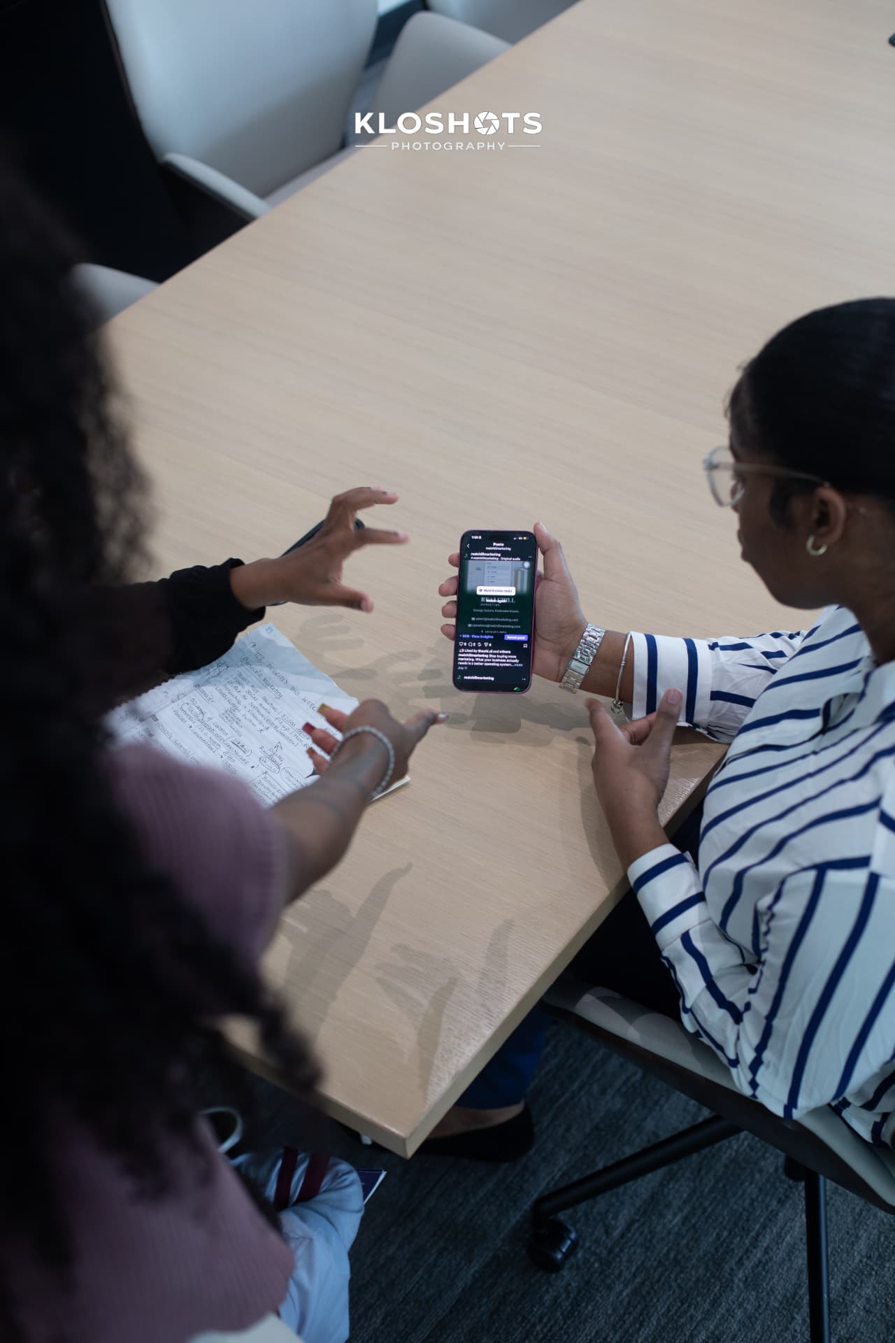 Instructor reviewing a social media post on a phone with a student
